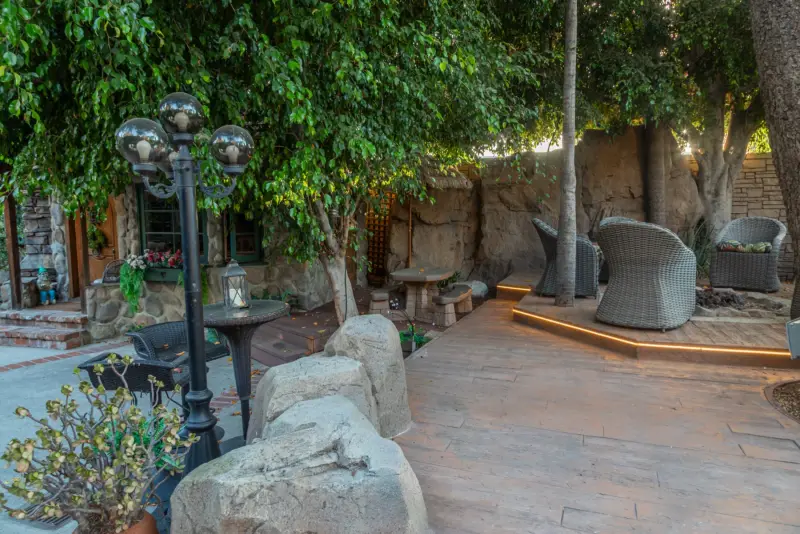 Lamps, boulders and lounge chairs in the courtyard at The Enchanted Manor
