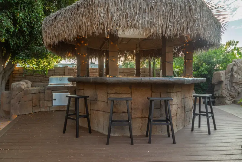 The thatched gazebo bar and its bar stools at The Enchanted Manor