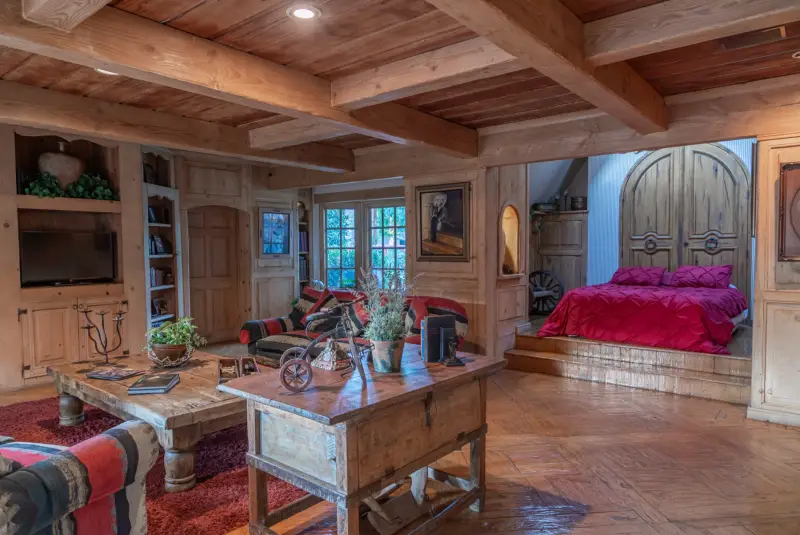 The Great Room: beamed ceiling, rugs and a queen bed at The Enchanted Manor