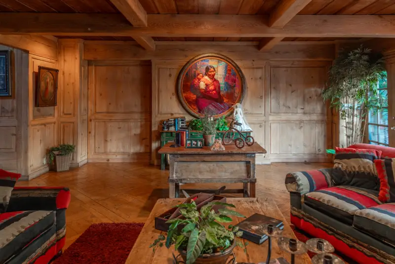 A painted portrait set into the wood panelling at The Enchanted Manor