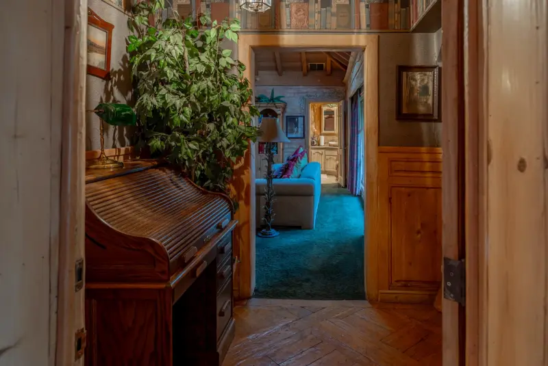 A roll-top desk in the hallway at The Enchanted Manor