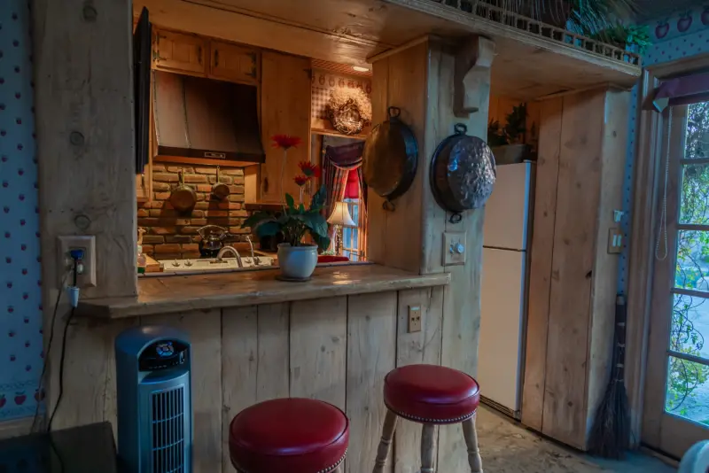 The kitchen counter and red bar stools in the Inn at The Enchanted Manor