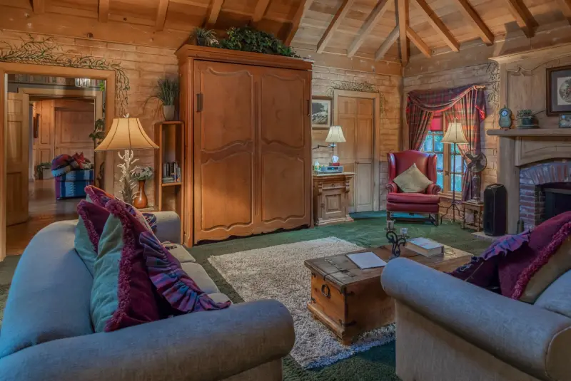 The Inn living room under its vaulted wood ceiling at The Enchanted Manor