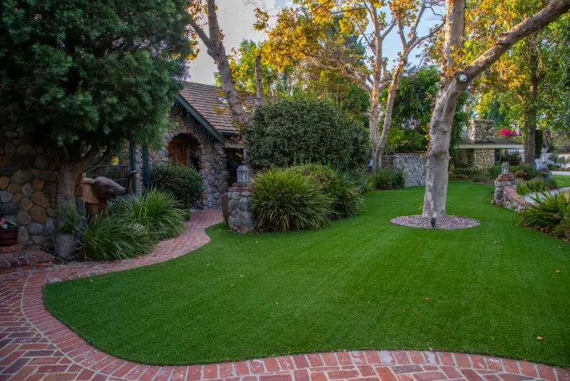 Brick edging and lawn beneath the great trees at The Enchanted Manor