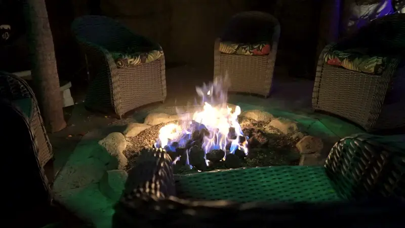 The fire pit burning after dark at The Enchanted Manor