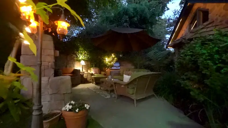 Lanterns glowing on the private patio at dusk at The Enchanted Manor