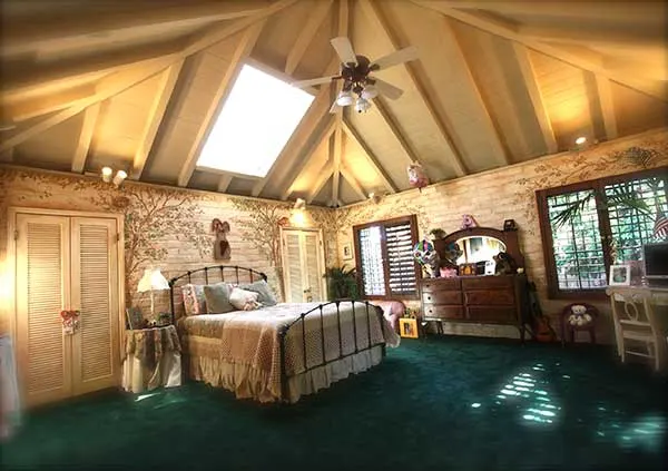 A vaulted bedroom with a skylight at The Enchanted Manor