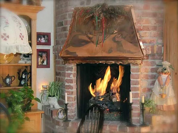 A brick kitchen fireplace at The Enchanted Manor
