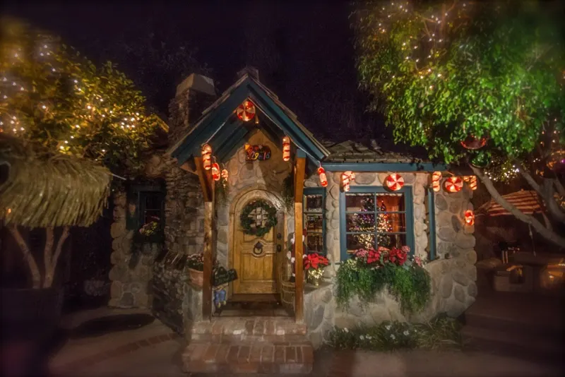 The front cottage at night, dressed for the holidays at The Enchanted Manor