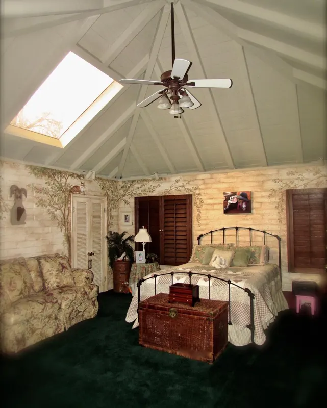 A bedroom under a skylight at The Enchanted Manor