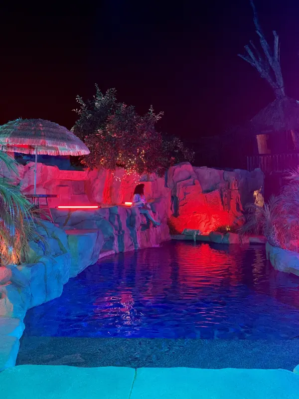 The pool lit red and pink at The Enchanted Manor