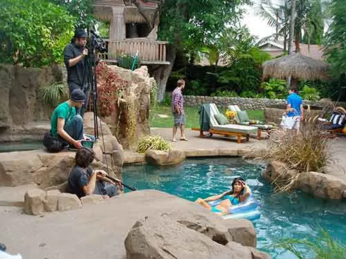 A crew shooting beside the pool at The Enchanted Manor