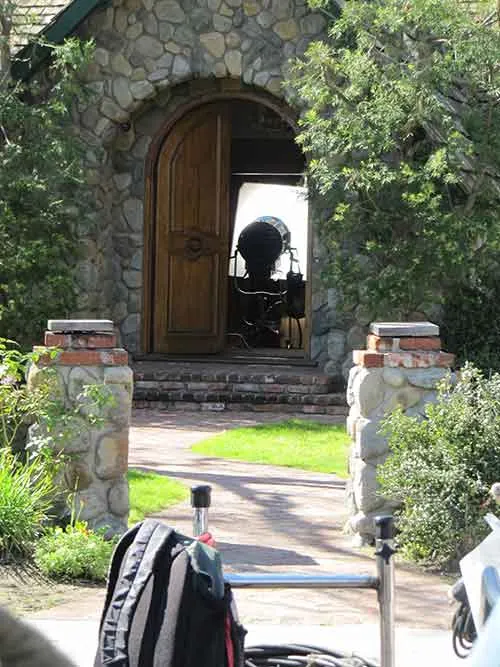 Camera ready at the arched front door at The Enchanted Manor