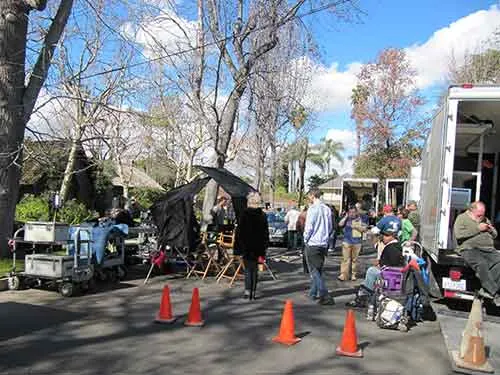 Production trucks on the cul — de — sac at The Enchanted Manor