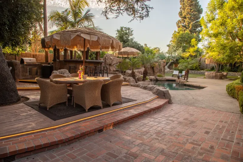 Dining on the deck beside the thatched gazebo bar at The Enchanted Manor
