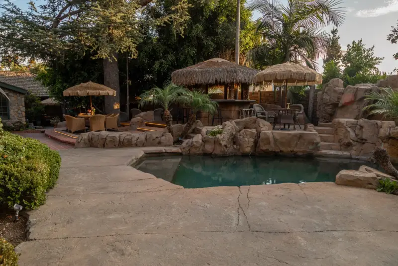 The full length of the pool and palapas at The Enchanted Manor